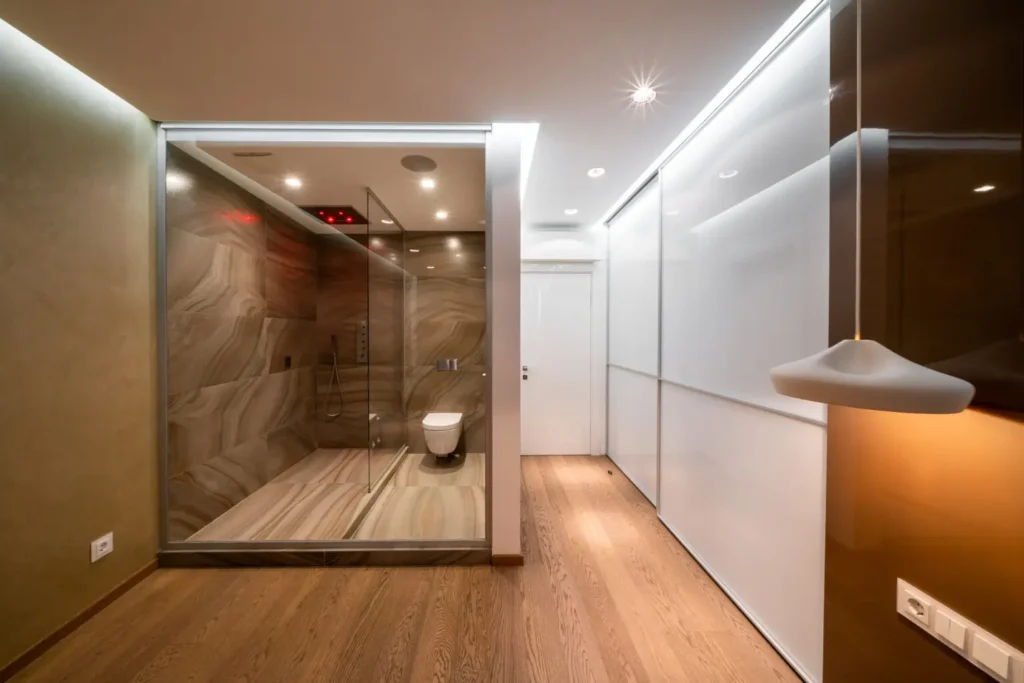 Switchable Glass Redefines Privacy Expectations: But How? Luxury bathroom featuring switchable smart glass enclosure for on-demand privacy, modern aesthetics, and space optimization.