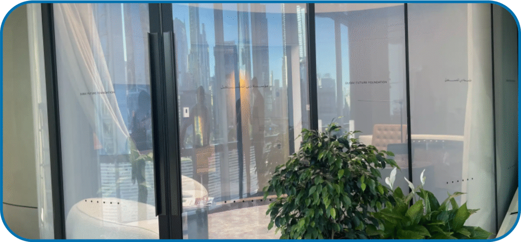 A luxury hotel bathroom with a smart glass shower partition, shown in its 'ON' clear state, creating a spacious, open feel.