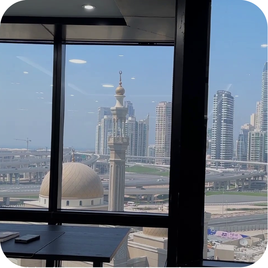 Home (new) A large commercial office in Dubai using a switchable smart glass partition wall, shown in its 'OFF' opaque state for complete privacy.