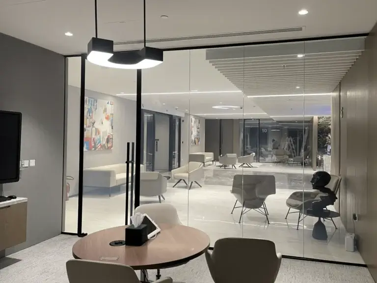 Frameless office glass partition creating an open and modern workspace in Dubai.